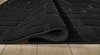 Gibbswell Washable 5' x 7' Area Rug - Sims Furniture